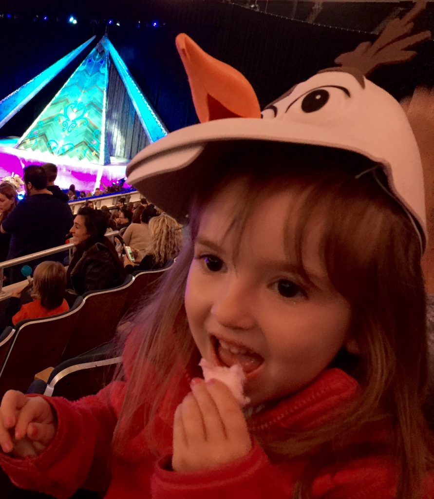 Lily Eating Cotton Candy in Her Olaf Hat